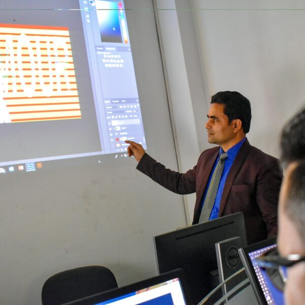 a man standing in front of a projector screen giving a presentation